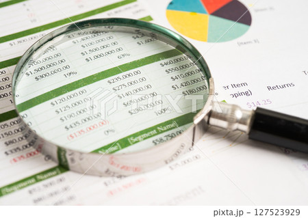 Magnifying glass on graph paper. Financial development, Banking Account, Statistics, Investment Analytic research data economy, Business. 127523929