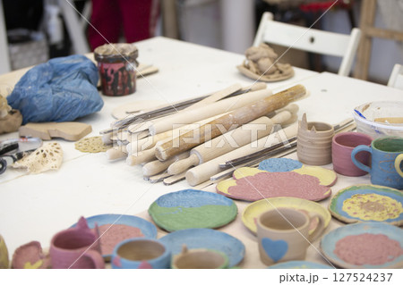 Clay products in the workshop on the table. Clay modeling master class. Clay products in the workshop on the table. Clay modeling master class. 127524237