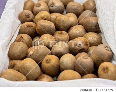 Ripe juicy selected kiwis are sold in plastic boxes by weight in an elite supermarket. Close-up 127524779
