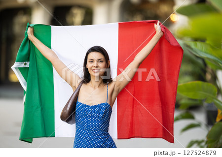 Young woman with Italian flag on city street Young woman with Italian flag on city street 127524879