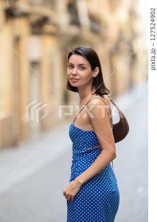 Young woman posing on city street 127524902