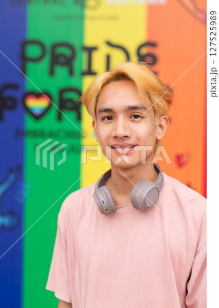 Handsome gay man portrait against pride rainbow background 127525989