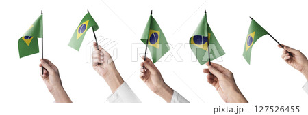The Brazil flag in hand in different angles on a white background 127526455