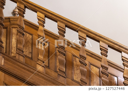 Elegant close-up of a beautifully carved wooden staircase Elegant close-up of a beautifully carved wooden staircase 127527446