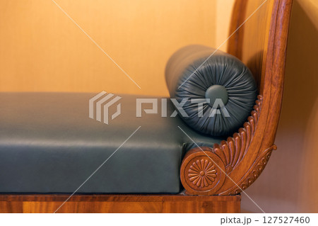 Close-up of a beautifully designed wooden sofa with intricate carvings 127527460