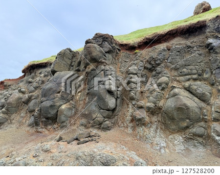 Giant's Causeway is a UNESCO World Heritage Site on Northern Ireland's Antrim Coast, famous for hexagonal stones by volcanic activity and beautiful coast. 127528200
