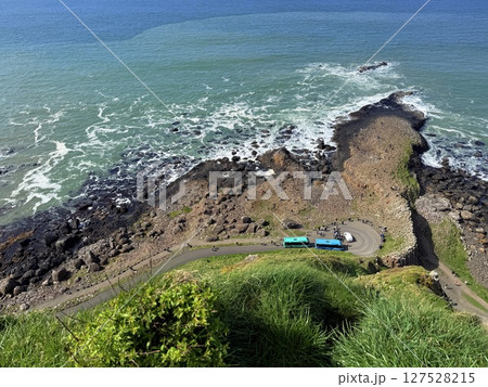 Giant's Causeway is a UNESCO World Heritage Site on Northern Ireland's Antrim Coast, famous for hexagonal stones by volcanic activity and beautiful coast. 127528215