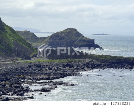 Giant's Causeway is a UNESCO World Heritage Site on Northern Ireland's Antrim Coast, famous for hexagonal stones by volcanic activity and beautiful coast. 127528222
