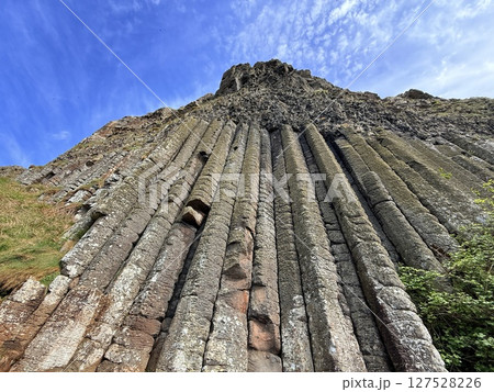 Giant's Causeway is a UNESCO World Heritage Site on Northern Ireland's Antrim Coast, famous for hexagonal stones by volcanic activity and beautiful coast. 127528226