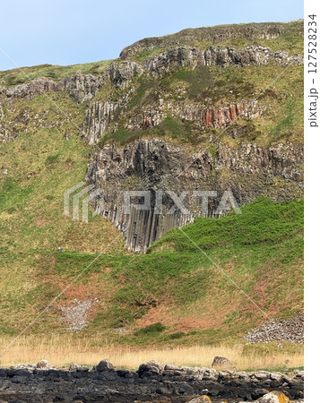 Giant's Causeway is a UNESCO World Heritage Site on Northern Ireland's Antrim Coast, famous for hexagonal stones by volcanic activity and beautiful coast. Giant's Causeway is a UNESCO World Heritage Site on Northern Ireland's Antrim Coast, famous for hexagonal stones by volcanic activity and beautiful coast. 127528234