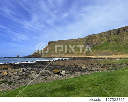 Giant's Causeway is a UNESCO World Heritage Site on Northern Ireland's Antrim Coast, famous for hexagonal stones by volcanic activity and beautiful coast. 127528235