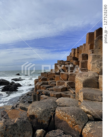 Giant's Causeway is a UNESCO World Heritage Site on Northern Ireland's Antrim Coast, famous for hexagonal stones by volcanic activity and beautiful coast. Giant's Causeway is a UNESCO World Heritage Site on Northern Ireland's Antrim Coast, famous for hexagonal stones by volcanic activity and beautiful coast. 127528260