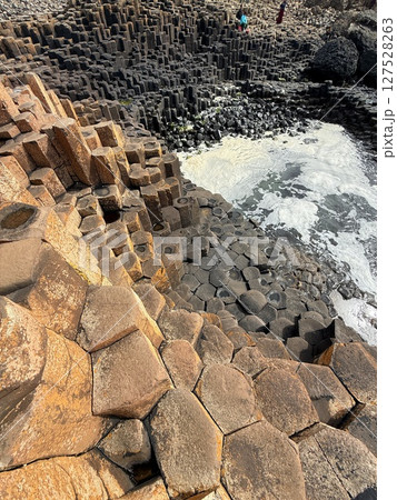 Giant's Causeway is a UNESCO World Heritage Site on Northern Ireland's Antrim Coast, famous for hexagonal stones by volcanic activity and beautiful coast. Giant's Causeway is a UNESCO World Heritage Site on Northern Ireland's Antrim Coast, famous for hexagonal stones by volcanic activity and beautiful coast. 127528263
