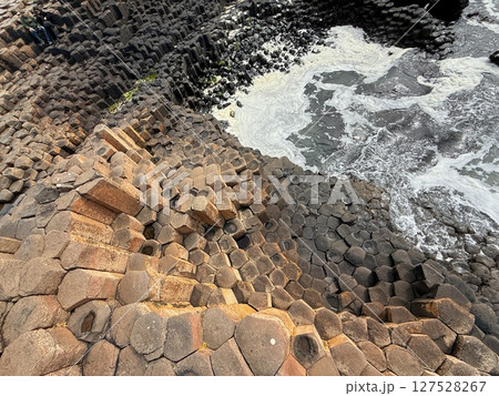 Giant's Causeway is a UNESCO World Heritage Site on Northern Ireland's Antrim Coast, famous for hexagonal stones by volcanic activity and beautiful coast. Giant's Causeway is a UNESCO World Heritage Site on Northern Ireland's Antrim Coast, famous for hexagonal stones by volcanic activity and beautiful coast. 127528267