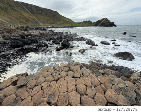 Giant's Causeway is a UNESCO World Heritage Site on Northern Ireland's Antrim Coast, famous for hexagonal stones by volcanic activity and beautiful coast. 127528278