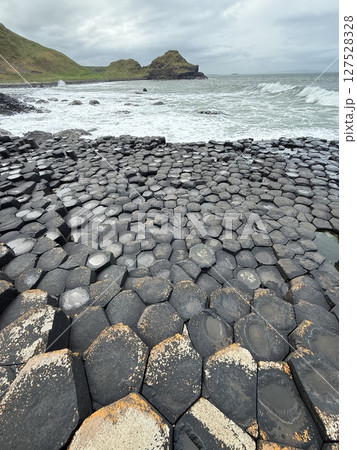 Giant's Causeway is a UNESCO World Heritage Site on Northern Ireland's Antrim Coast, famous for hexagonal stones by volcanic activity and beautiful coast. Giant's Causeway is a UNESCO World Heritage Site on Northern Ireland's Antrim Coast, famous for hexagonal stones by volcanic activity and beautiful coast. 127528328