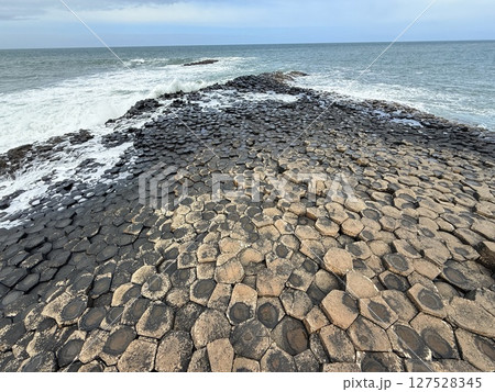 Giant's Causeway is a UNESCO World Heritage Site on Northern Ireland's Antrim Coast, famous for hexagonal stones by volcanic activity and beautiful coast. Giant's Causeway is a UNESCO World Heritage Site on Northern Ireland's Antrim Coast, famous for hexagonal stones by volcanic activity and beautiful coast. 127528345