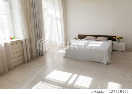 bedroom interior with windows and bed 127529193