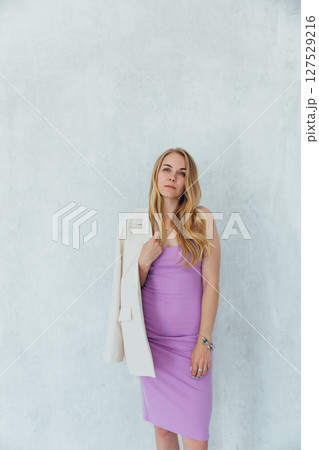 Portrait of a beautiful blonde woman in a purple dress on a white background Portrait of a beautiful blonde woman in a purple dress on a white background 127529216