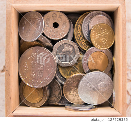 Old golden and silber coins in wood box. Money from France, Poland, Italy, England, Austria, Czech Republic, China, Croatia, Denmark, Netherlands. Various coins for business. Financial concept. 127529386