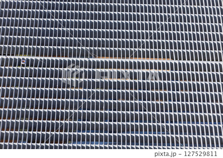 Closeup of Metallic Ventilation Grille with Repetitive Horizontal Slats Abstract Texture 127529811