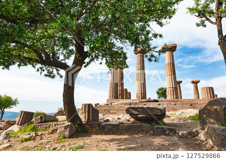 Temple of Athena ruins in Assos, Turkey framed by trees with ancient Doric columns under blue spring sky 127529866