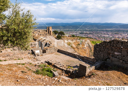 Scenic view of Pergamon theatre and city of Bergama from upper acropolis with ancient ruins and olive tree in foreground Scenic view of Pergamon theatre and city of Bergama from upper acropolis with ancient ruins and olive tree in foreground 127529878