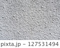 Rough white textured wall provides a detailed closeup of its uneven surface, suitable for backgrounds or design work. Unique structure and simplicity, it's ideal for creative projects 127531494