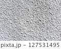Rough white textured wall provides a detailed closeup of its uneven surface, suitable for backgrounds or design work. Unique structure and simplicity, it's ideal for creative projects 127531495