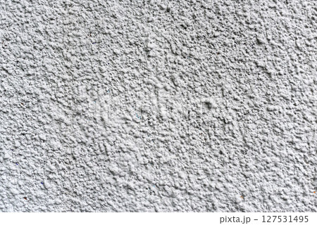 Rough white textured wall provides a detailed closeup of its uneven surface, suitable for backgrounds or design work. Unique structure and simplicity, it's ideal for creative projects Rough white textured wall provides a detailed closeup of its uneven surface, suitable for backgrounds or design work. Unique structure and simplicity, it's ideal for creative projects 127531495