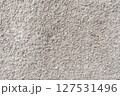 Rough white textured wall provides a detailed closeup of its uneven surface, suitable for backgrounds or design work. Unique structure and simplicity, it's ideal for creative projects 127531496