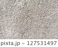 Rough white textured wall provides a detailed closeup of its uneven surface, suitable for backgrounds or design work. Unique structure and simplicity, it's ideal for creative projects 127531497