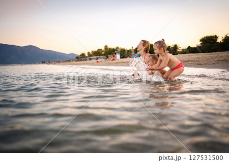 Joyful summer fun by the seaside in Greece with children Joyful summer fun by the seaside in Greece with children 127531500