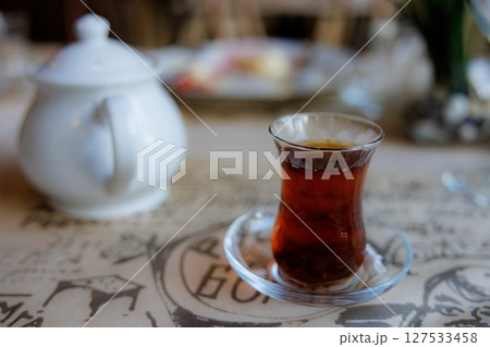 Discover the rich flavors of traditional tea served in a cozy cafe during afternoon relaxation Discover the rich flavors of traditional tea served in a cozy cafe during afternoon relaxation 127533458