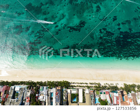 Sun reflection over the turquoise sea water and waves in white sand beach. Boracay, Philippines. 127533856