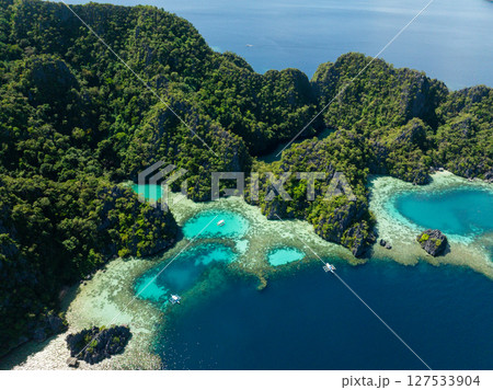 Drone view of Hidden Lagoon with turquoise water and Black Lake in Coron, Palawan. Philippines. Drone view of Hidden Lagoon with turquoise water and Black Lake in Coron, Palawan. Philippines. 127533904