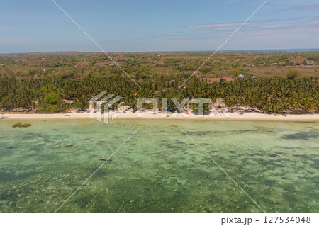 Scenic landscape of shoreline with fishing boats and sandy beaches. Bantayan Island, Cebu, Philippines. 127534048