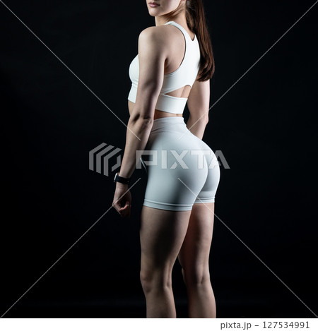 athletic female body on dark background, fitness woman, athletic girl torso 127534991