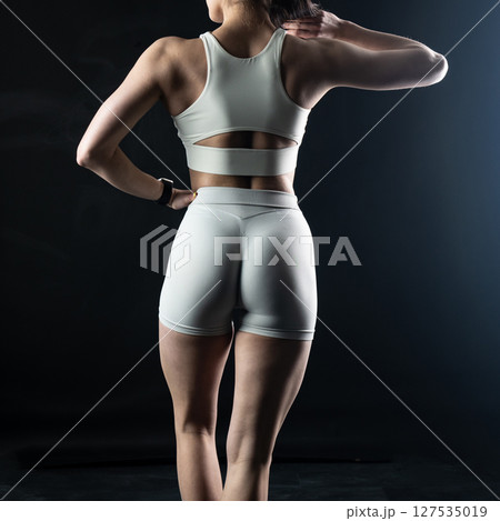 athletic female body on dark background, fitness woman, athletic girl torso athletic female body on dark background, fitness woman, athletic girl torso 127535019