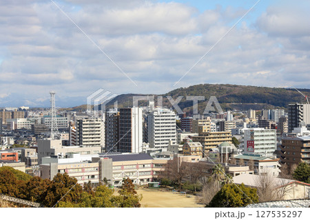 Kumamoto, Japan - January 25, 2023: Landscape of Kumamoto city from Kumamoto castle. Kumamoto is the capital city in Kyushu, Japan. Kumamoto, Japan - January 25, 2023: Landscape of Kumamoto city from Kumamoto castle. Kumamoto is the capital city in Kyushu, Japan. 127535297