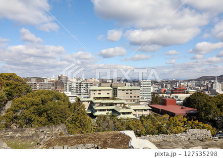 Kumamoto, Japan - January 25, 2023: Landscape of Kumamoto city from Kumamoto castle. Kumamoto is the capital city in Kyushu, Japan. Kumamoto, Japan - January 25, 2023: Landscape of Kumamoto city from Kumamoto castle. Kumamoto is the capital city in Kyushu, Japan. 127535298