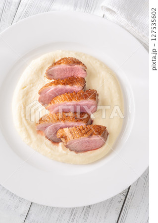 Sliced Fried Duck Breast Served with Mashed Potatoes on White Dinner Plate Sliced Fried Duck Breast Served with Mashed Potatoes on White Dinner Plate 127535602