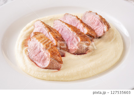 Sliced Fried Duck Breast Served with Mashed Potatoes on White Dinner Plate Sliced Fried Duck Breast Served with Mashed Potatoes on White Dinner Plate 127535603