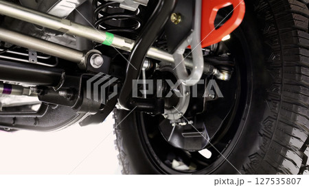 Car suspension part. Close up of a rear car suspension and exhaust system. such as coil springs link arms axle housing and performance exhaust. For auto engineering or car suspension part industry use 127535807