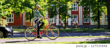 Portrait young adult pretty woman with red vintage retro bike and pin-up casual outfit green city park bright sunny summer day. Happy beautiful female person cycling outdoors. Healthy lifestyle 127535848