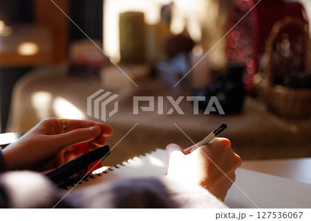 Capturing creativity in a cozy workspace filled with warm light and inspiring objects 127536067