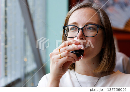 Enjoying a warm beverage with a view from a cozy urban cafe in the heart of the city 127536093