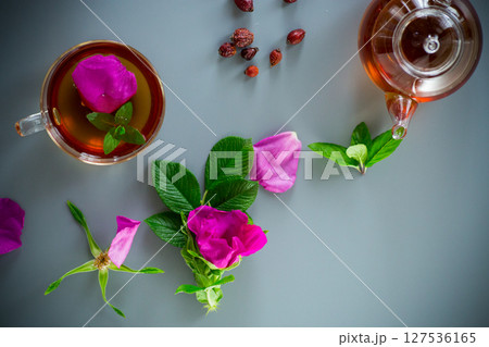 Herbal rosehip and mint tea in a cup and teapot from above Herbal rosehip and mint tea in a cup and teapot from above 127536165