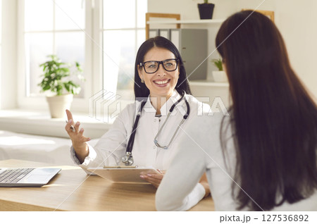 Woman sitting back in the doctor's office and listening the recommendations. Woman sitting back in the doctor's office and listening the recommendations. 127536892