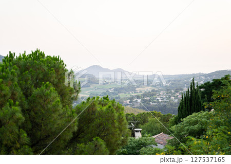Peaceful countryside with mountains, greenery, and a tranquil atmosphere 127537165